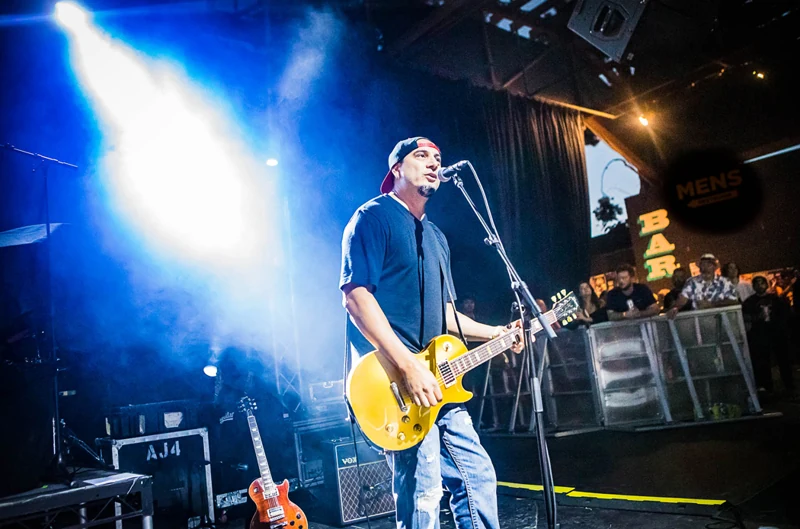 Guitarist under blue and yellow lights