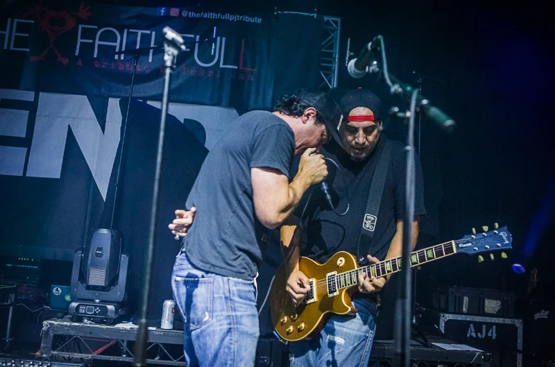 Guitarists performing live
