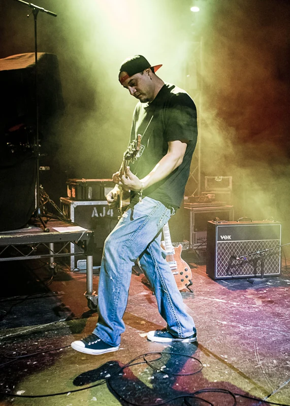 Singer at the microphone under green stage lights